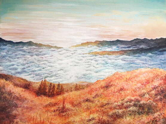 warm orange hills containing a few trees and shrubs with blue rising fog. there's a pinkish sunrise in the distance.