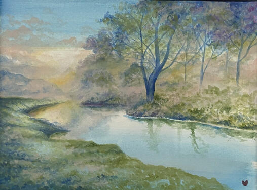a blue stream cuts through an early morning scene of pink fog crawling through a small forest.